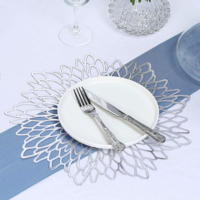 Elegant silver floral placemat with white plate and cutlery.