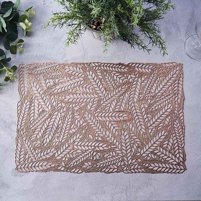 Decorative leaf-patterned placemat on a textured surface.