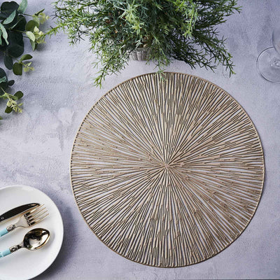 Round woven placemat with textured design on a grey surface.