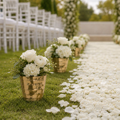 White floral wedding aisle with gold vases and rose petal walkway
