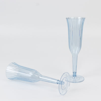 Blue plastic champagne flutes in two styles, one upright and one tilted.