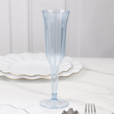 Blue vintage-style fluted champagne glass on a marble surface.