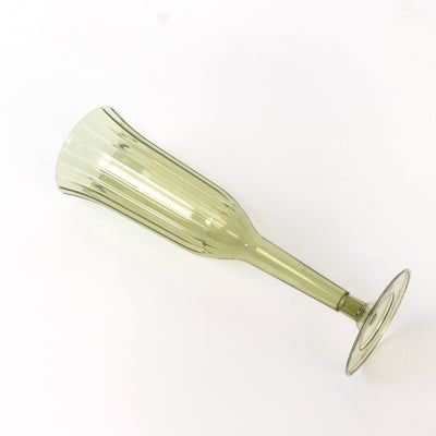 Green champagne flute with ribbed design on plain white background