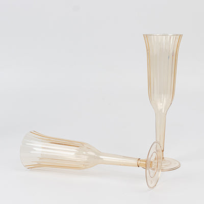Set of elegant clear champagne flutes with gold accents