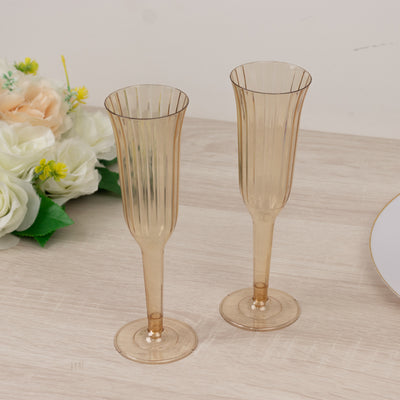 Two elegant champagne flutes in a soft amber color.