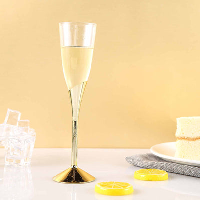 Elegant champagne flute with lemon slices and cake on a golden background.
