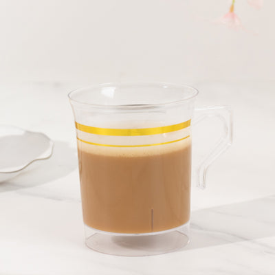 Clear glass mug with coffee and yellow stripe design.