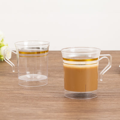 Clear double wall coffee mug with gold stripes, showcasing hot and cold beverages.