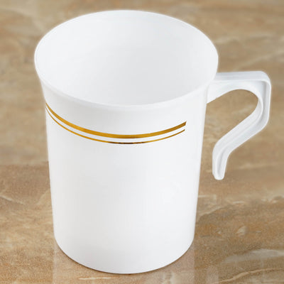 White plastic cup with gold stripe detail on a marble surface.