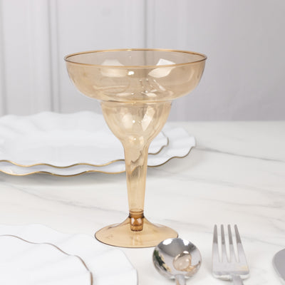 Elegant amber glass dessert cup with a gold rim on a marble table.