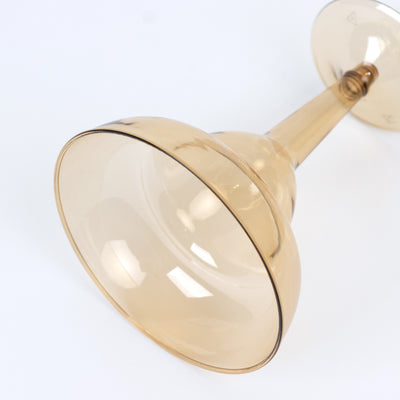 Smoky amber glass drinking goblet on a plain background