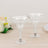 Clear glass dessert cups on a wooden table with floral accents.