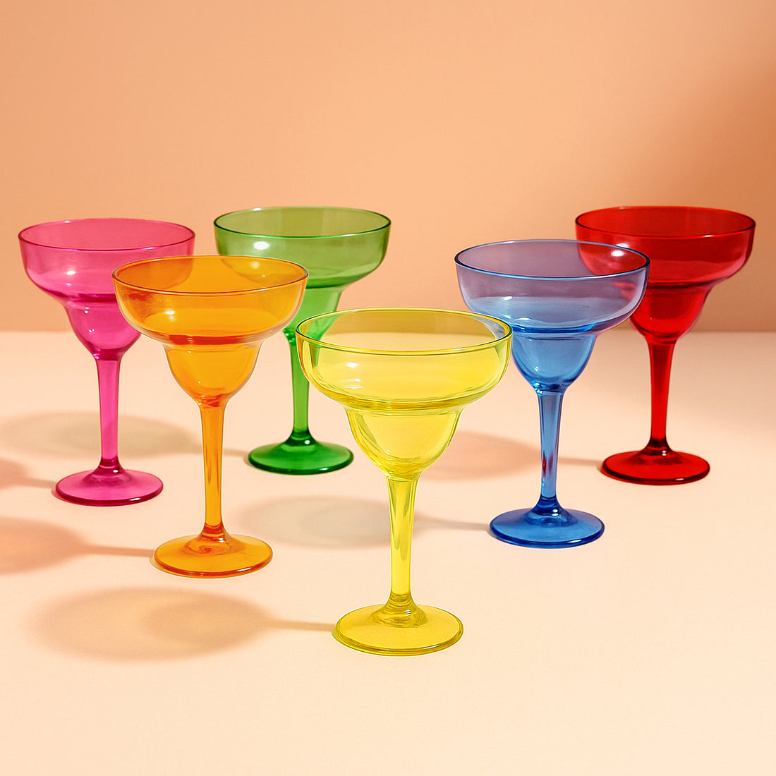 Colorful margarita glasses in vibrant shades of pink, orange, green, blue, and red.