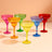 Colorful margarita glasses in vibrant shades of pink, orange, green, blue, and red.