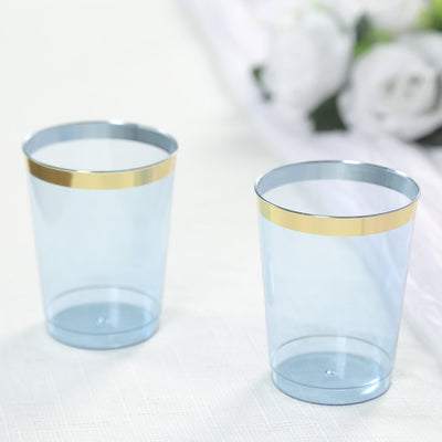Blue plastic cups with gold bands on the rim.