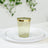 Gold-trimmed green plastic cup on a white plate.