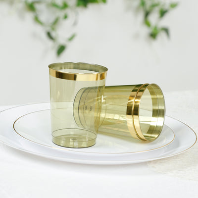 Gold rimmed clear plastic cups on a white plate.
