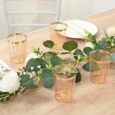 Elegant transparent cups with gold rims, perfect for celebrations or gatherings.