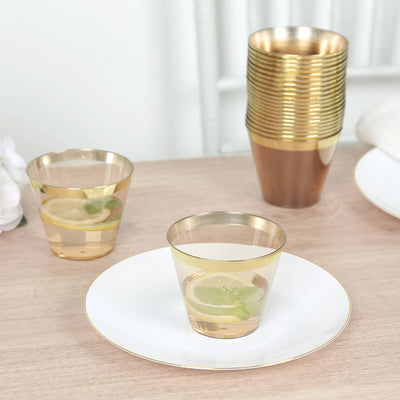 Gold rimmed plastic cups with drinks on a wooden table.
