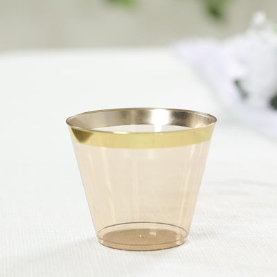 Gold-trimmed transparent cup on a white surface