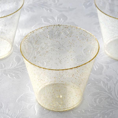 Clear plastic cup with gold glitter rim, perfect for parties and celebrations.