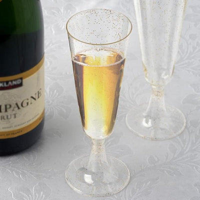 Elegant champagne flutes with sparkling bubbly against a textured background.