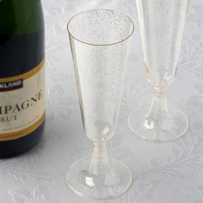 Elegant champagne flutes with gold accents on a textured background.