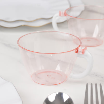 Clear plastic cup with pink accents on a marble surface.
