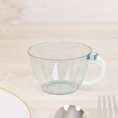 Clear plastic cup with white handle on a wooden table.