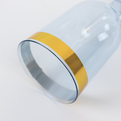 Clear glass tumbler with a gold stripe.