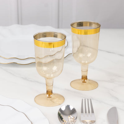 Elegant vintage champagne glasses with gold rim on a marble table.