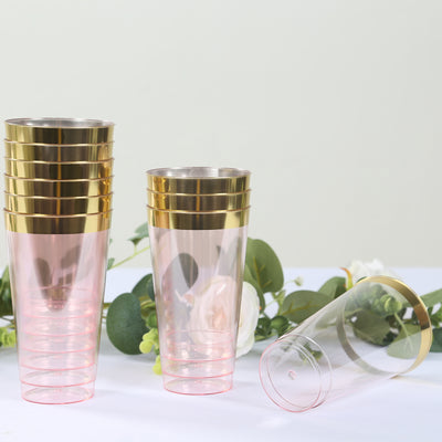 Stack of elegant pink and gold plastic cups on a table