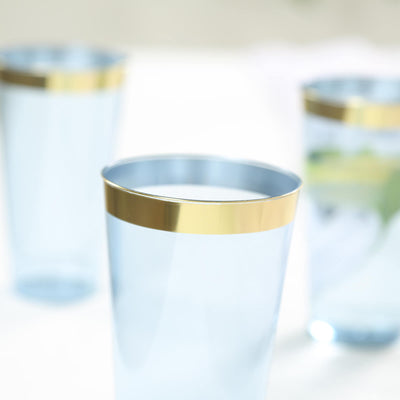 Blue glass tumblers with gold rims.