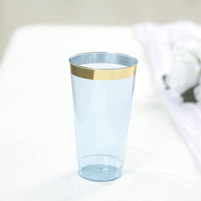 Blue plastic cup with gold rim on a plain background.