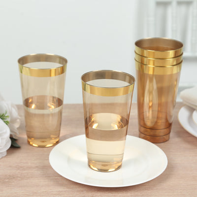 Gold-trimmed transparent drinking glasses on a table setting.
