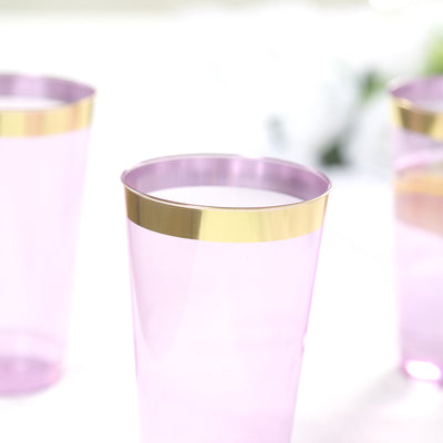 Purple plastic cups with gold rims on a light background.