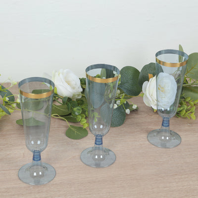 Set of three elegant blue champagne flutes with gold rims and floral accents.