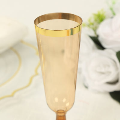 Gold-trimmed champagne flute in soft amber color.