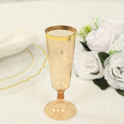 Elegant champagne flute with gold rim on a table setting.
