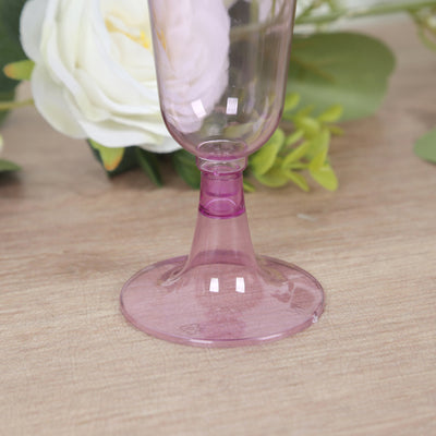 Purple plastic champagne flute on a wooden surface.
