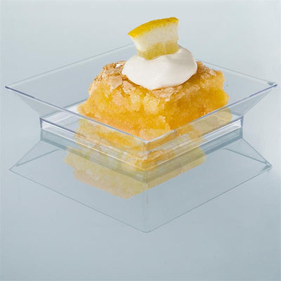 Lemon dessert with whipped cream in a clear glass dish