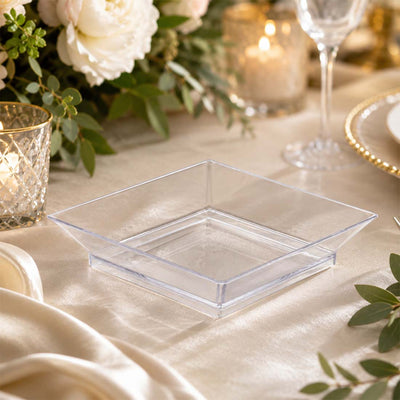 Clear square plastic serving dish on elegant gold wedding table setting