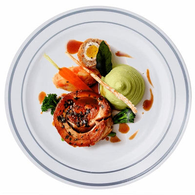 Gourmet dish featuring roasted meat, vegetables, and green puree on a white plate