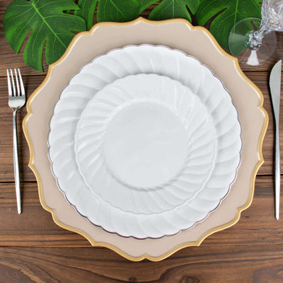 Elegant stacked dinner plates on a wooden table with decorative leaves.
