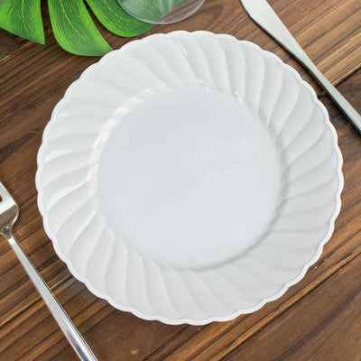 Elegant white scalloped plate on wooden table setting.