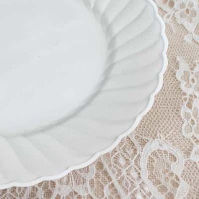 White ceramic plate with a scalloped edge on lace background.