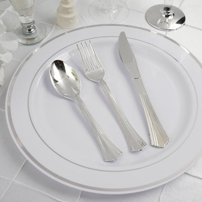 Elegant silver cutlery set on a white plate.