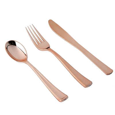 Rose gold cutlery set: spoon, fork, and knife on a white background.