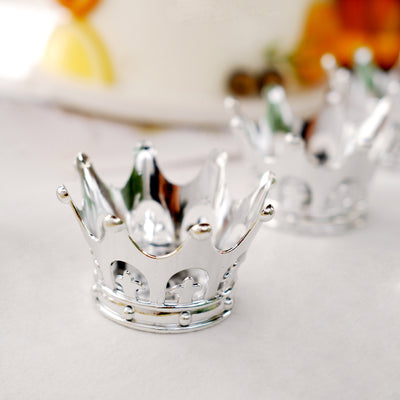 Silver crown-shaped cake topper for celebrations.