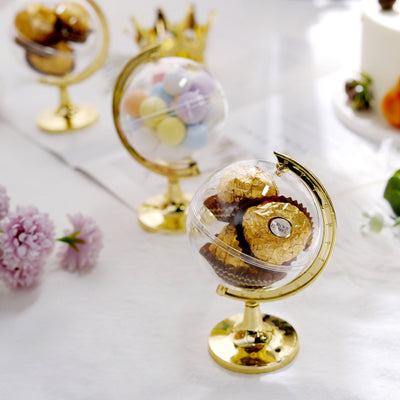 Decorative globe displays with assorted candies and chocolates.